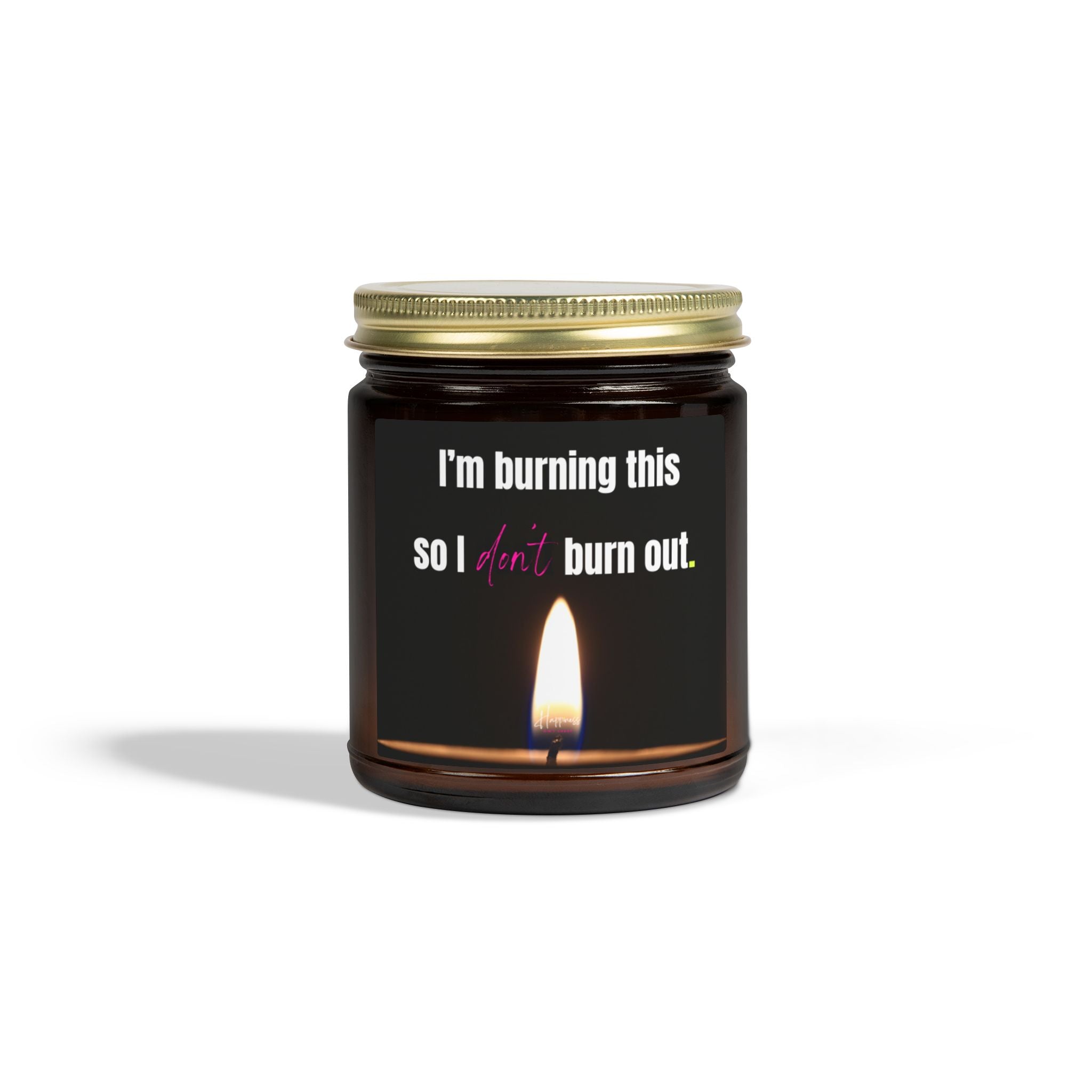 Candle in an amber glass jar with a gold lid, and a label that says 'I'm burning this so I don't burn out'